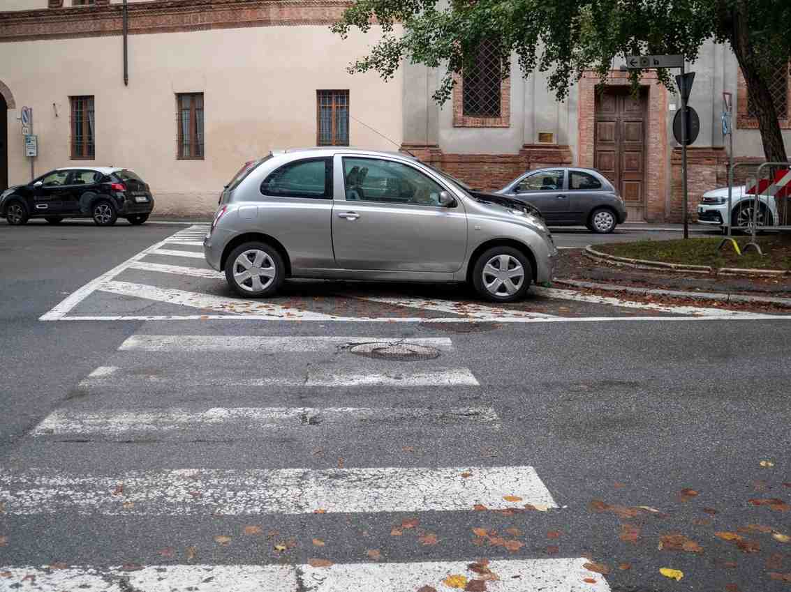 A car blocking a crosswalk, symbolizing crosswalk right-of-way violations and the potential civil liability in Georgia.