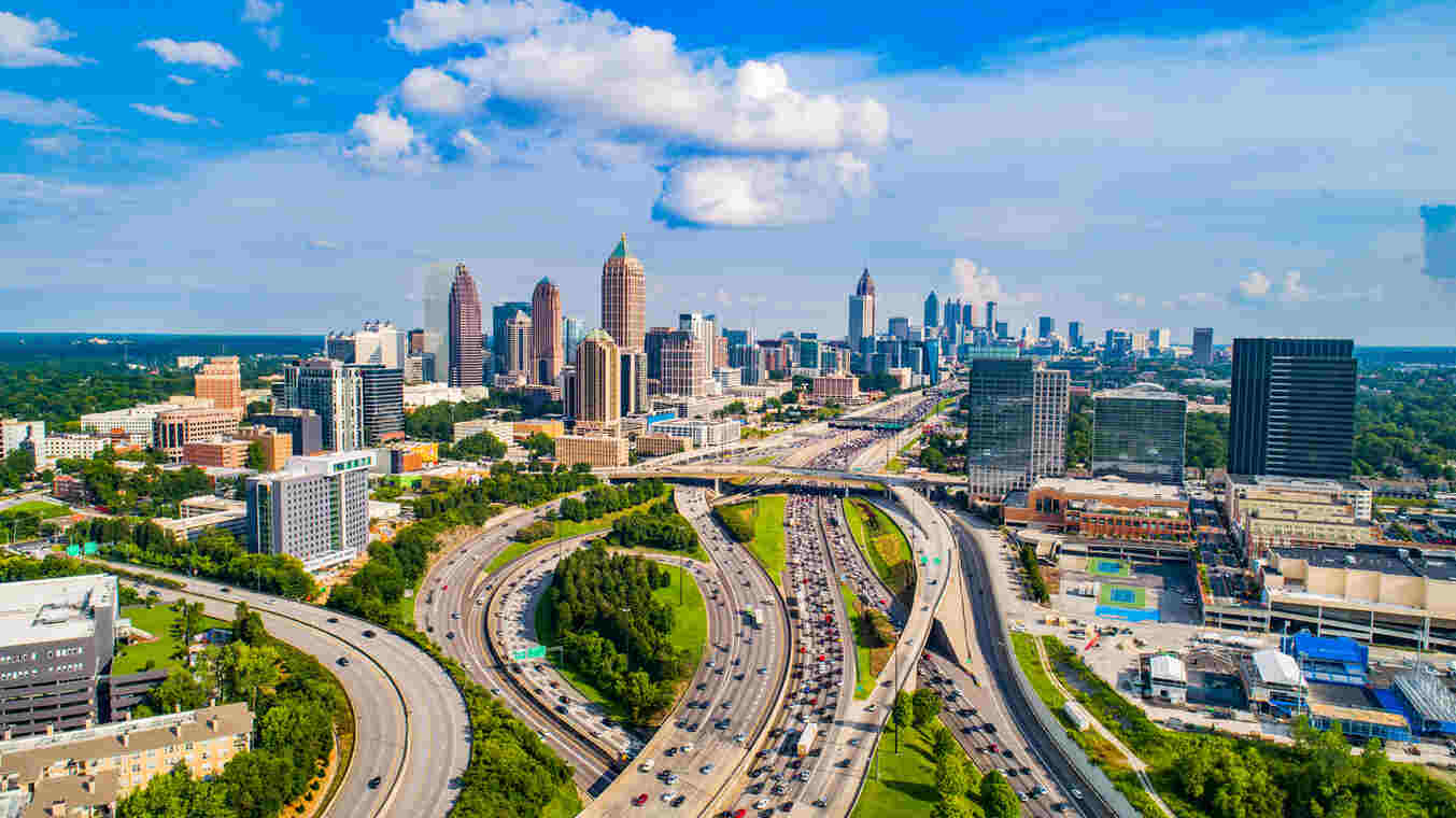Aerial view of a busy highway in Atlanta, showing merging lanes and traffic congestion, representing the risk of collisions during merging and ramp transitions.
